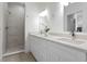 Bright bathroom features a double vanity with modern fixtures and a tiled walk-in shower at 9919 Cypress Park Dr, Orlando, FL 32824