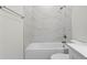 Bathtub with shower and white tile in bathroom at 9919 Cypress Park Dr, Orlando, FL 32824