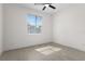 Bright bedroom with neutral tile flooring, ceiling fan, and a window providing natural light at 9919 Cypress Park Dr, Orlando, FL 32824