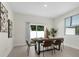 Bright dining room featuring a modern table set, neutral colors, and sliding glass door to the backyard at 9919 Cypress Park Dr, Orlando, FL 32824