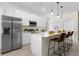Bright, modern kitchen featuring stainless steel appliances, a spacious island with seating, and clean white cabinets at 9919 Cypress Park Dr, Orlando, FL 32824