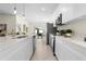 Bright kitchen with stainless steel appliances, quartz counters, and an open view to the dining area at 9919 Cypress Park Dr, Orlando, FL 32824