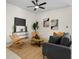 Cozy living room featuring neutral tones, comfortable seating, and a minimalist entertainment center at 9919 Cypress Park Dr, Orlando, FL 32824