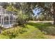 A backyard with a pond and tall trees is a great place to relax at 10166 Hidden Dunes Ln, Orlando, FL 32832