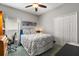 This bedroom features a ceiling fan and a large closet for storage at 10166 Hidden Dunes Ln, Orlando, FL 32832