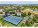 Aerial view of community amenities including tennis courts, playground, pool, and athletic fields at 10166 Hidden Dunes Ln, Orlando, FL 32832