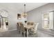 Formal dining room with a neutral palette, stylish lighting, and seating for six at 10166 Hidden Dunes Ln, Orlando, FL 32832
