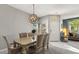 Bright dining room featuring a modern chandelier and seating for six at 10166 Hidden Dunes Ln, Orlando, FL 32832