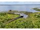 Scenic view of a dock on a expansive lake, surrounded by lush foliage at 10166 Hidden Dunes Ln, Orlando, FL 32832