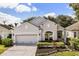 Charming single-story home with well-manicured landscaping and a two-car garage at 10166 Hidden Dunes Ln, Orlando, FL 32832