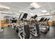 Community gym with cardio machines, weights, and a ceiling fan at 10166 Hidden Dunes Ln, Orlando, FL 32832