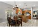 Well-lit kitchen with an island and dining table, perfect for Gathering meals at 10166 Hidden Dunes Ln, Orlando, FL 32832