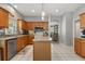 Bright kitchen featuring a center island, stainless steel appliances, and tile flooring at 10166 Hidden Dunes Ln, Orlando, FL 32832