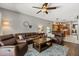 Inviting living room with hardwood floors and comfortable seating adjacent to the kitchen and breakfast nook at 10166 Hidden Dunes Ln, Orlando, FL 32832