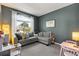 Cozy living room with an oversized window and comfortable seating at 10166 Hidden Dunes Ln, Orlando, FL 32832