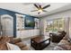 Inviting living room with a ceiling fan and sliding glass doors that provide pool access at 10166 Hidden Dunes Ln, Orlando, FL 32832