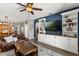 Comfortable living room with built-in shelving, ceiling fan, and lots of natural light at 10166 Hidden Dunes Ln, Orlando, FL 32832