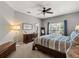 Comfortable main bedroom with a large window, ceiling fan, and dresser at 10166 Hidden Dunes Ln, Orlando, FL 32832