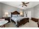 Spacious main bedroom featuring a ceiling fan and dark wood furniture at 10166 Hidden Dunes Ln, Orlando, FL 32832