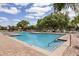 Community pool with lounge chairs and staircase for easy access at 10166 Hidden Dunes Ln, Orlando, FL 32832