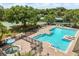Community swimming pool with lounge chairs, hot tub and tennis courts at 10166 Hidden Dunes Ln, Orlando, FL 32832