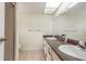 Bathroom featuring dual sinks, large mirror, and tiled shower at 1030 Blue Horizon Dr, Deltona, FL 32725