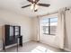 Neutral bedroom showcasing window, ceiling fan, and a desk at 1030 Blue Horizon Dr, Deltona, FL 32725