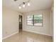 A dining area with tile floors, a modern light fixture, and bright window at 1030 Blue Horizon Dr, Deltona, FL 32725