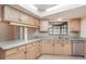 Well-lit kitchen with light wood cabinetry, a window, and a spacious countertop at 1030 Blue Horizon Dr, Deltona, FL 32725