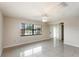 Bright living room featuring tile floors, a ceiling fan, and large windows at 1030 Blue Horizon Dr, Deltona, FL 32725