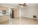 A spacious living room adjacent to the kitchen with stainless steel appliances at 1030 Blue Horizon Dr, Deltona, FL 32725