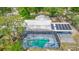 Aerial view of the property showcasing the pool, deck, solar panels, and mature landscaping in a serene setting at 105 Elizabeth Ave, Altamonte Springs, FL 32701