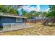 View of the backyard with a wooden deck, providing space for outdoor dining and relaxation at 105 Elizabeth Ave, Altamonte Springs, FL 32701