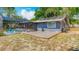 Backyard view showcasing the wooden deck, screened pool area, and lush green landscaping for serene outdoor living at 105 Elizabeth Ave, Altamonte Springs, FL 32701