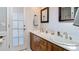 Bathroom with dual sinks and wood cabinets features plenty of light at 105 Elizabeth Ave, Altamonte Springs, FL 32701