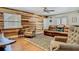 Cozy living room with wood-look accent wall, ceiling fan, and comfortable seating arrangement at 105 Elizabeth Ave, Altamonte Springs, FL 32701