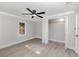 Bright bedroom boasts wood-look floors, ample closet space, and a modern ceiling fan at 120 East St, Altamonte Springs, FL 32701
