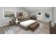 This well-lit bedroom has a modern aesthetic, wood-look floors, and updated decor at 120 East St, Altamonte Springs, FL 32701