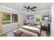 Cozy bedroom with neutral decor, large windows, ceiling fan, and stylish furnishings at 120 East St, Altamonte Springs, FL 32701
