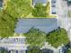 Overhead view of a well maintained property with ample parking and mature trees surrounding the building at 130 Lewfield Cir # 130, Winter Park, FL 32792