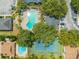Aerial view showcases the community's pool, tennis courts, and lush, mature landscaping at 130 Lewfield Cir # 130, Winter Park, FL 32792