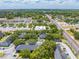 Community aerial with nearby retail, lush landscaping, and easy access to major roads at 130 Lewfield Cir # 130, Winter Park, FL 32792