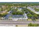 Aerial view of the community with mature trees, well-maintained landscaping, parking, and nearby road access at 130 Lewfield Cir # 130, Winter Park, FL 32792