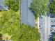 Overhead view of building surrounded by mature trees and ample parking space for residents and visitors at 130 Lewfield Cir # 130, Winter Park, FL 32792