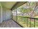 Screened balcony offering an outdoor retreat with views of mature trees and green landscape at 130 Lewfield Cir # 130, Winter Park, FL 32792