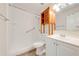 Bright bathroom featuring a walk-in shower, a single sink vanity, and wood cabinet at 130 Lewfield Cir # 130, Winter Park, FL 32792