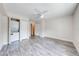 Bedroom with light wood flooring, a washer and dryer, and a view to the entrance at 130 Lewfield Cir # 130, Winter Park, FL 32792