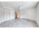 Bedroom with light wood flooring, two closets, and a view to the entrance at 130 Lewfield Cir # 130, Winter Park, FL 32792