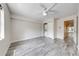 Bedroom with light wood flooring, a washer and dryer, and a view to the entrance at 130 Lewfield Cir # 130, Winter Park, FL 32792