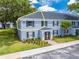 Well-maintained blue brick building with mature trees and well-manicured lawns at 130 Lewfield Cir # 130, Winter Park, FL 32792